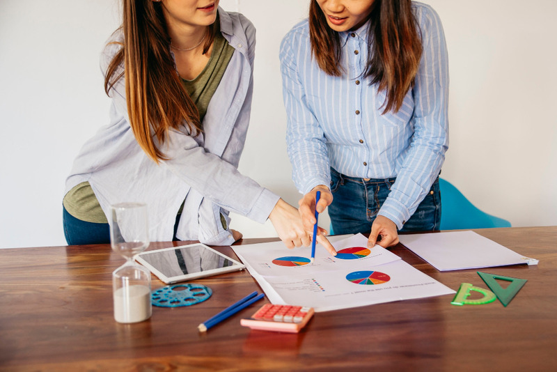 crop-girls-discussing-analysis-data (1)